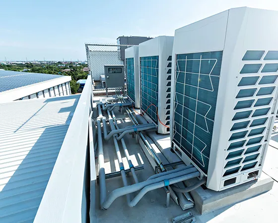 Commercial HVAC installation on a rooftop, showing units and piping.